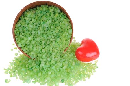 Salt for aromatic bath in clay dish with red heart on white backgroundの写真素材