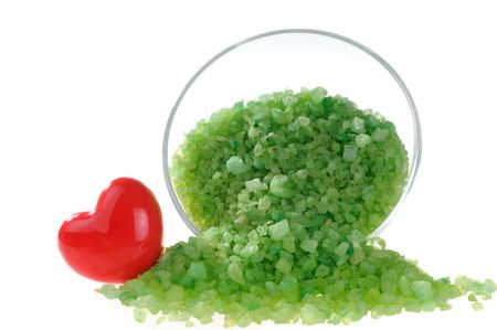 Scattered salt for aromatic bath with red heat on white background.の写真素材