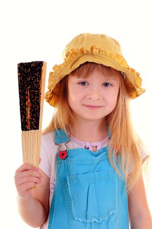 Nice girl in blue suit is playing with a fan on white backgroundの写真素材