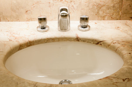 Faucet with handles and white sinkの写真素材