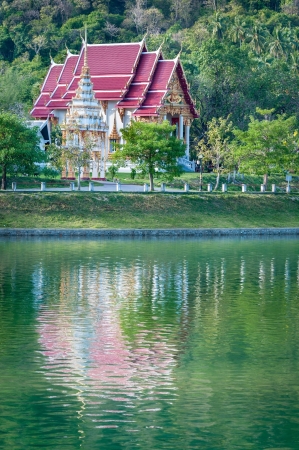 Fairy-tale buddhist temple with reflection in a lakeの写真素材