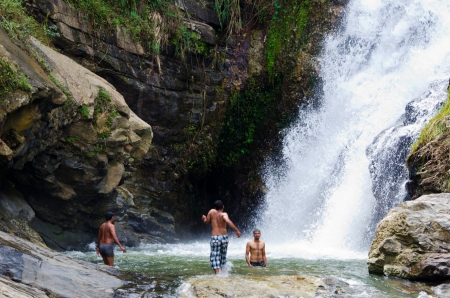 Ella, Sri Lanka - December 09, 2011: Sri Lankian teenagers take a bath in Ravana Falls.  It ranks as one of the widest waterfalls in the countryのeditorial素材