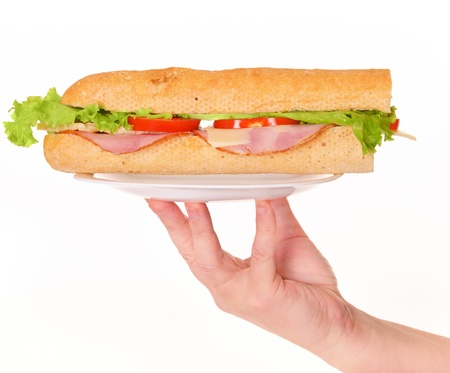 Fresh sandwich with meat and salad on plate in hand isolated on white backgroundの写真素材