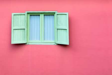 Vintage window with green shutters on pink wall, Singaporeの写真素材