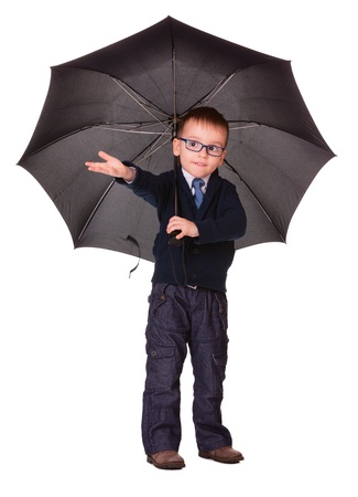 Boy in black clothes under big black umbrella check is it raining or not   Isolated on whiteの写真素材