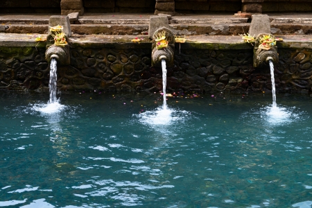 Fountains and pool with holy spring water in Tirta Empul temple, Bali, Indonesia の写真素材
