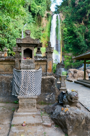 Traditional Balinese house of spirits with sacred waterfall Gingit on backgroundの写真素材