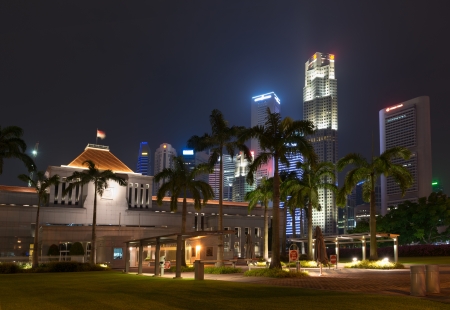 Singapore parliament building illuminated at night with skyscraper on backgroundのeditorial素材