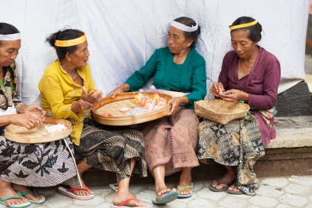 TAMPAK SIRING, BALI, INDONESIA - SEP 21: Women make sweets for balinese traditional offerings to gods in temple Puru Tirtha Empul on Sep 21, 2012 in Tampak Siring, Bali, Indonesiaのeditorial素材