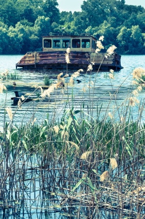 Wrecked abandoned ship on a river after nuclear disaster in Chernobyl, Ukraineの写真素材