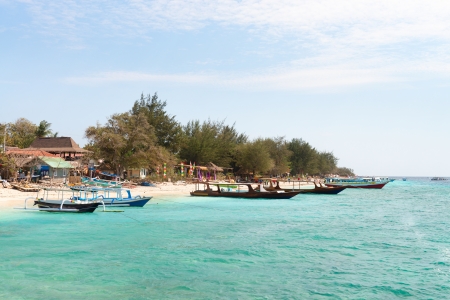 Small wooden tourist and fishing long boats near sand beach, Gili Trawangan island, Indonesia のeditorial素材