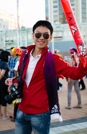 KIEV, UKRAINE - JUL 1  Joyful football fan with camera is going to EURO 2012 final match Spain vs  Italy on July 1, 2012 in Kiev, Ukraineのeditorial素材