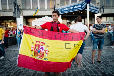 KIEV, UKRAINE - JUL 1  Spanish football fan with the flag goes to EURO 2012 final match Spain vs  Italy on July 1, 2012 in Kiev, Ukraineのeditorial素材