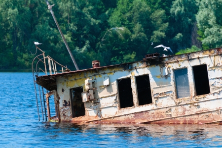 Wrecked abandoned ship on a river after nuclear disaster in Chernobyl, Ukraineの写真素材