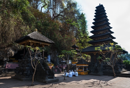 BALI, INDONESIA - SEP 26: Men in white traditional clothes take part in sacred ceremony in Goa Lawah Bat Cave on Sep 26, 2012 in Bali, Indonesiaのeditorial素材