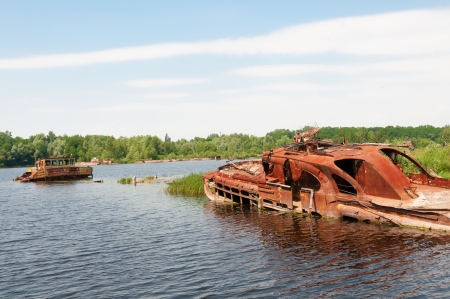 Wrecked abandoned ships on a river after nuclear disaster in Chernobyl, Ukraineの写真素材