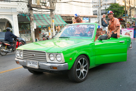 PHUKET, THAILAND - 07 FEB 2014: Phuket town residents on green car take part in procession of annual old Phuket town festival. のeditorial素材