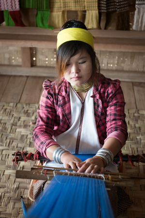 INLE LAKE, MYANMAR (BURMA) - 07 JAN 2014: Unidentified Padaung (Kayan Lahwi) tribe woman weave on traditional device. This tribe is called "long neck"ÂÂ because of metal rings around their necks.のeditorial素材