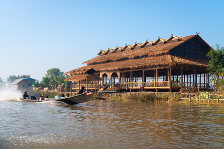 INLE LAKE, MYANMAR (Burma) - 07 JAN 2014: People transportation wooden long boat with motor fast move on blue water. Boats is a key transport type on Inle lake. のeditorial素材