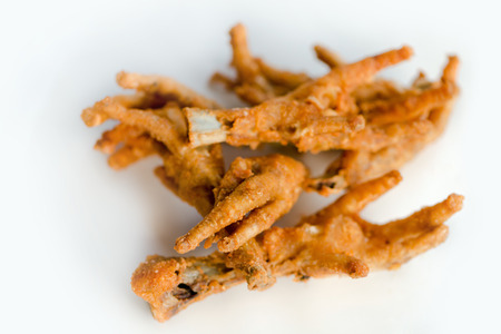 Deep fat fried chicken feet on white plateの写真素材