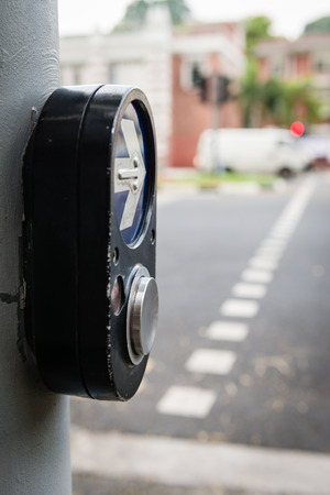 Crosswalk pedestrian signal button and sign to switch traffic lights on a city streetの写真素材