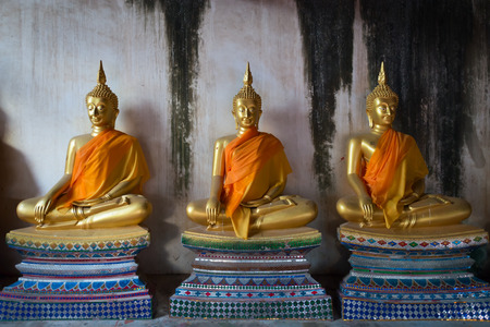 Old three Buddha statue in meditate bhumisparsha mudra posture at Wat Mahathat, Ayutthaya, Thailandのeditorial素材