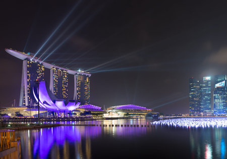 SINGAPORE  30 DEC 2013: Singapore's skyline with spotlights lit up over Marina Bay before the annual New Year's Celebration.のeditorial素材