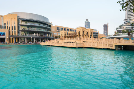 DUBAI UAE  16 JULY 2014: Beautiful contemporary architecture of Dubai Mall overlooking a clear blue decorative pool.のeditorial素材