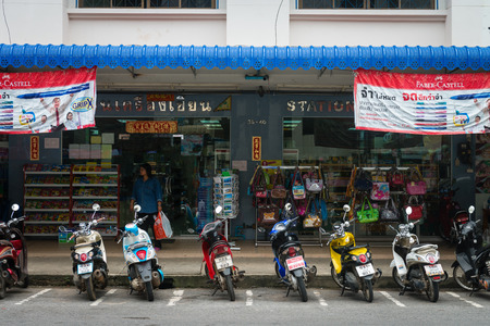 KRABI, THAILAND - 14 OCT 2014: Typical urban storefronts in Krabi, Thailand, with motorcycles parked curbsideのeditorial素材