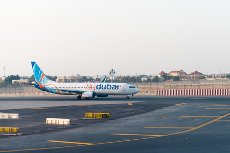 DUBAI, UAE - 17 JULY 2014: Fly Dubai passenger jet taxiing to the terminal after landing at Dubai International Airport.のeditorial素材