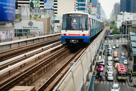BANGKOK, THAILAND - 07 MAY 2014: BTS metro Skytrain runs through the city centre above cars at...