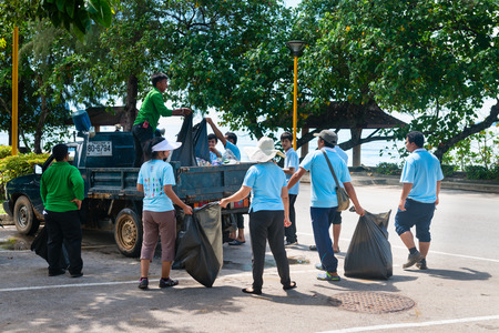 KRABI, THAILAND - 13 OCT 2014: People outdoors collecting garbage along the street and waste off the beach in Ao Nang, Krabiのeditorial素材