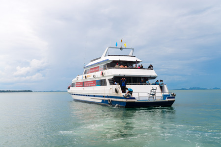 KRABI, THAILAND - 12 OCT 2014: Big luxury tourist charter boat ferry with tourists onboard off the mainland from Krabi to Phuket, Thailand.のeditorial素材