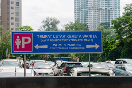 KUALA LUMPUR, MALAYSIA - 02 NOV 2014: Parking for lone woman, security parking, safety for woman alone, blue and pink sign for lone womans parking in the carpark.のeditorial素材