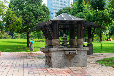 Refreshing granite water fountain and sign for fresh clean d?inking water set on paved outdoor park with lush green grassの写真素材