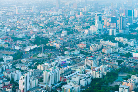 Overlooking perspective shot of Bangkok, Thailand's crowded, urban cityscape, in the hazy, early...