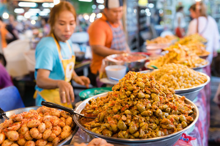 PHUKET, THAILAND - 9 APR 2016: Thai food stall with spice fruits on weekend night market in Phuket town.のeditorial素材
