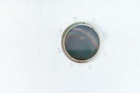 Batten round porthole on the ship white painted wallの写真素材