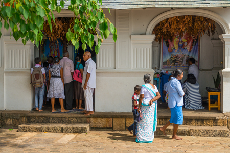 DAMBULLA, SRI LANKA - NOV 2016: Pilgrims near small Vishnu shrine in Golden cave temple complex.のeditorial素材