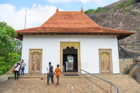 DAMBULLA, SRI LANKA - NOV 2016: Local pilgrims near entrance to Golden cave temple complexのeditorial素材