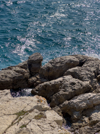 A close up of a rocky shore near the ocean, seaの写真素材