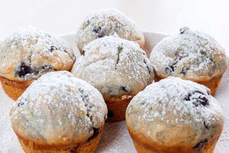 Homemade freshly baked muffins with berries on the plateの写真素材