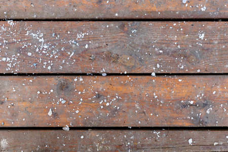 Winter background with wooden floor boards and snow outside.の写真素材