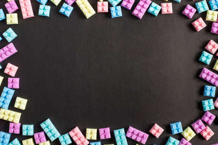 Frame of toy plastic blocks on black backgroundの写真素材