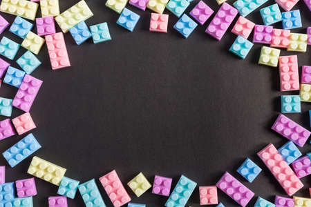 Frame of toy plastic blocks on black backgroundの写真素材