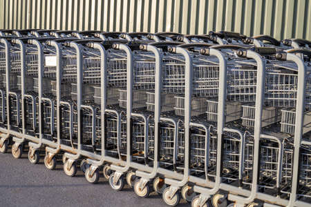 Shopping carts in a row outside a supermarketの写真素材