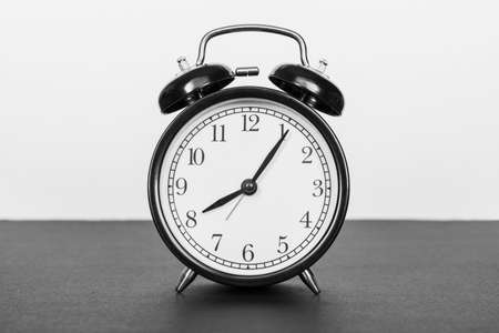 Classic alarm clock on black and white background. Time concept with copy space for text. Black and white image.の写真素材