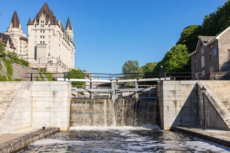Rideau Canal locks and luxury Fairmont Chateau Laurier hotel in Ottawa, Canada on a sunny day.のeditorial素材