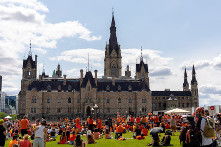 Ottawa, Canada - July 1, 2021: Cancel Canada Day protest rally on Parliament Hill in support of Indigenous people. Every Child Matters. People wearing orange shirts.のeditorial素材