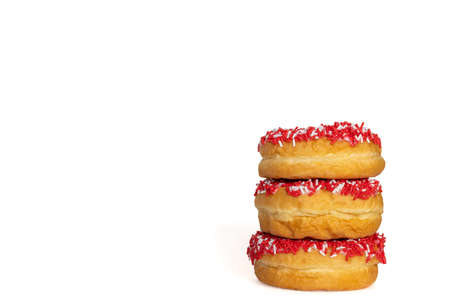 Three red donuts with sprinklers isolated on white background with copy space for textの写真素材